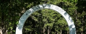 Moran State Park entrance arch in front of trees.