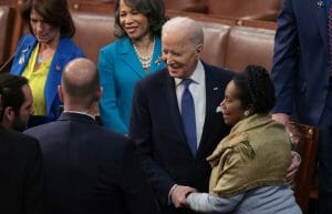 President Biden shakes hands with a Black woman.