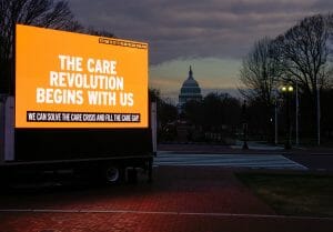 A care work billboard in DC