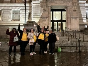 Domestic worker advocates celebrate a victory outside the DC Council.