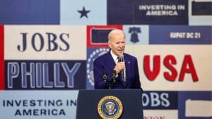 President Joe Biden speaks behind a podium