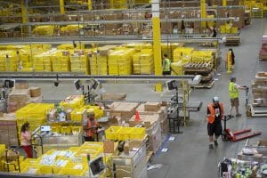 ROBBINSVILLE, NJ - AUGUST 1: Employees work at the Amazon Fulfillment Center on August 1, 2017 in Robbinsville, New Jersey. The more than 1 million square feet facility holds tens of millions of products, features more than 14 miles of conveyor belts, and employs more than 4,000 workers who pick, pack, and ship orders. Tomorrow Amazon will host a jobs fair to hire 50,000 positions in their fulfillment centers nationwide. (Photo by Mark Makela/Getty Images)